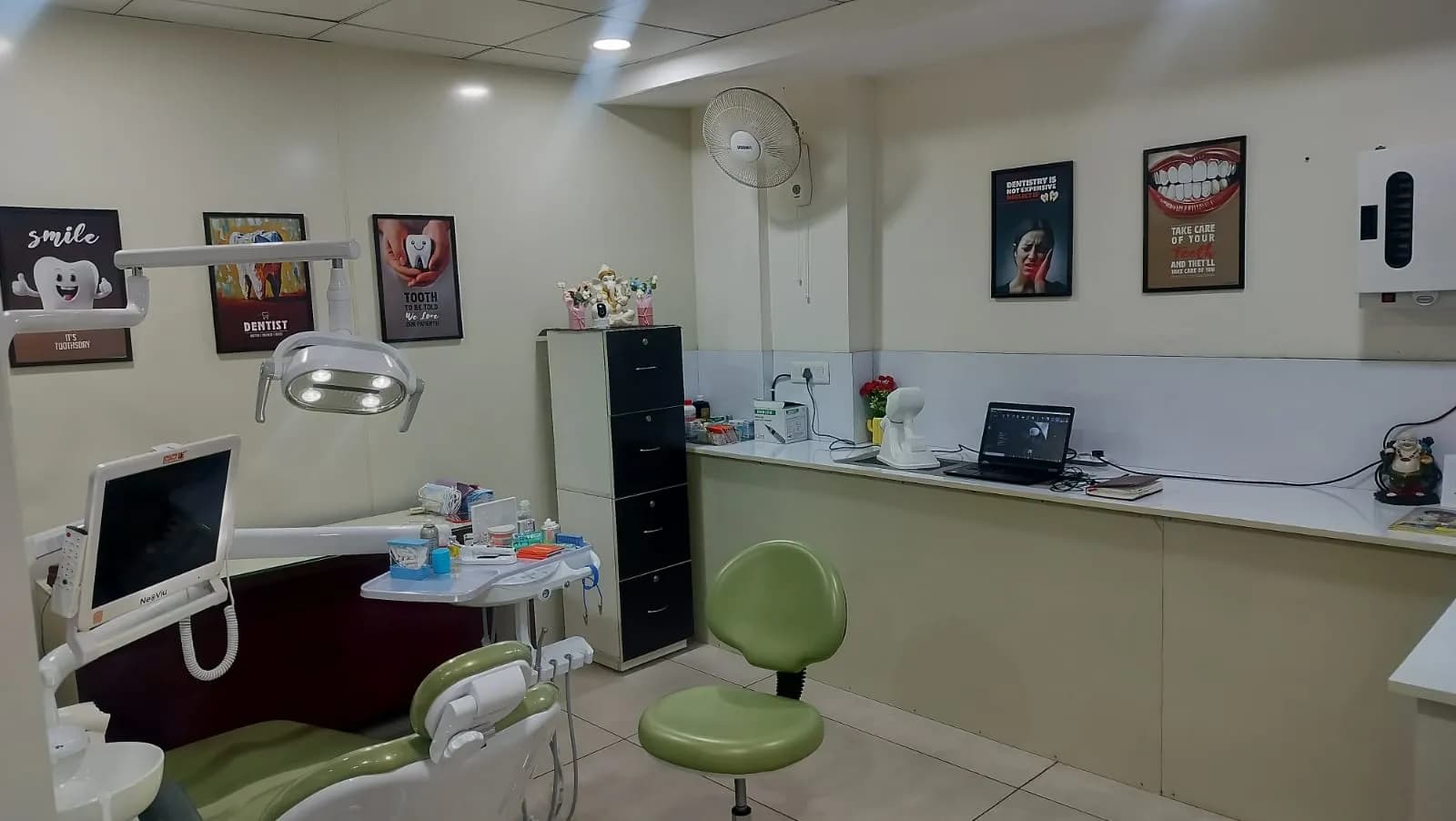 The work counter alongside the dental chair, with the treatment planning laptop and supplies laid out.